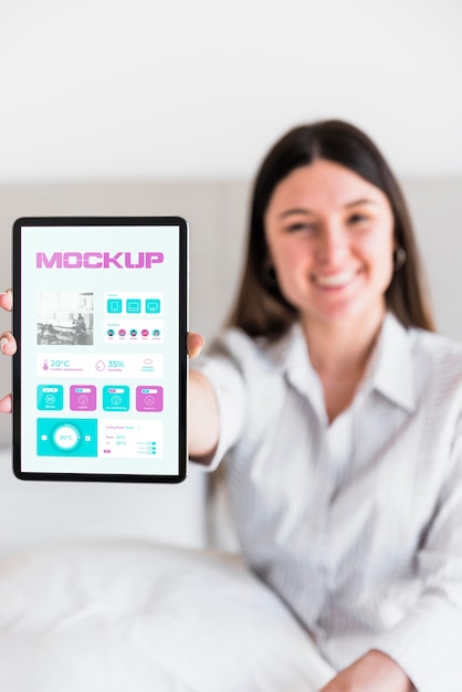 Smiley woman holding tablet with mock-up