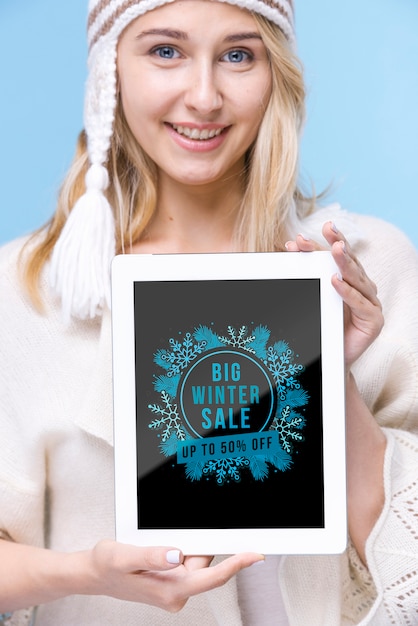 PSD smiley young woman holding tablet