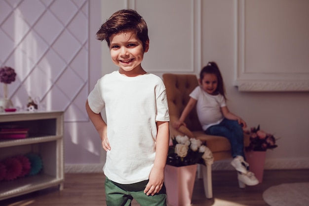 Smiling boy in white t-shirt posing for a photo