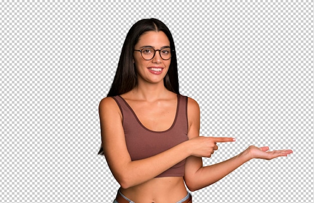 smiling feeling happy carefree and satisfied pointing to concept or idea on copy space on the side