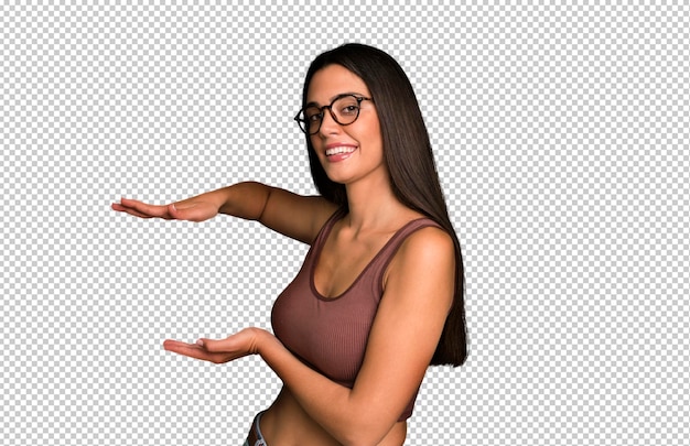 smiling feeling happy positive and satisfied holding or showing object or concept on copy space