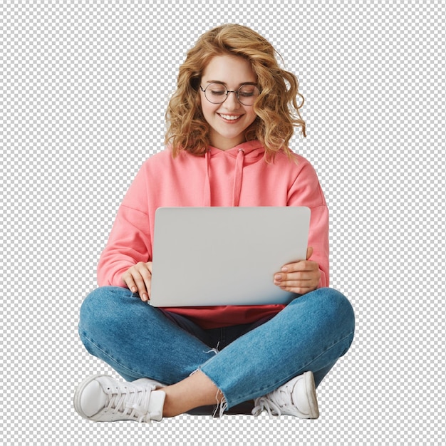 smiling female student writing essay sitting with laptop on floor