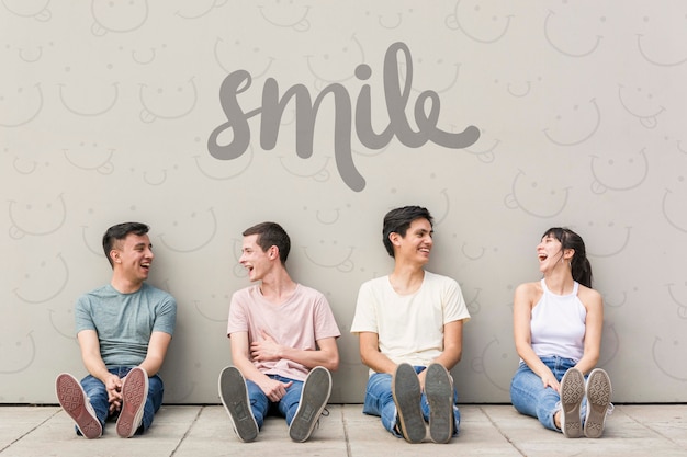 Smiling friends posing on the ground