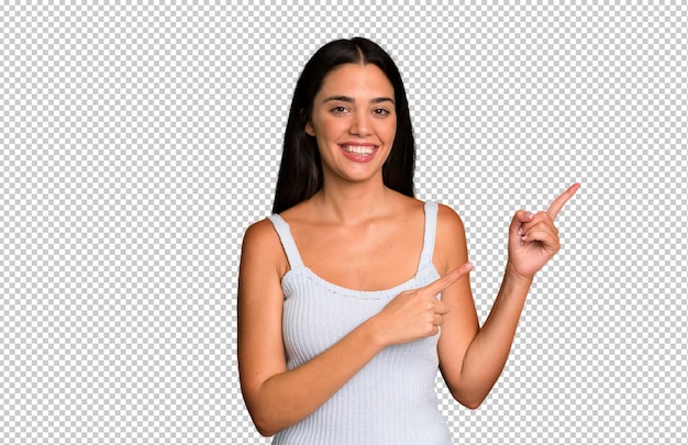 Smiling happily and pointing to side and upwards with both hands showing object in copy space