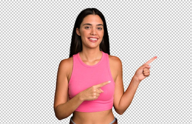 PSD smiling happily and pointing to side and upwards with both hands showing object in copy space