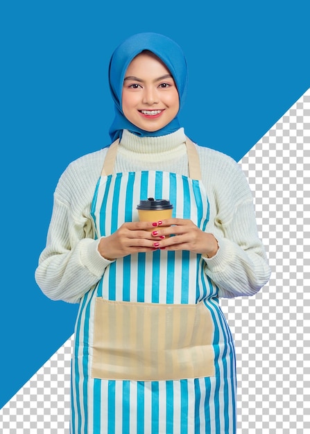 Smiling young asian muslim woman in her 20s wearing hijab and apron holding paper coffee cup with hands people housewife muslim lifestyle concept