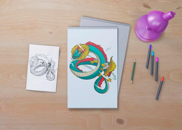 snake sketch on white sheets on table 