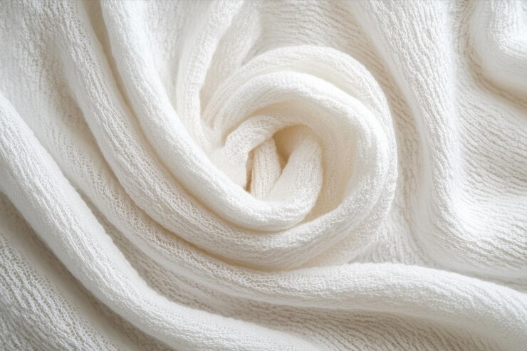 PSD soft white fabric elegantly spiraled showcasing texture and warmth in natural light at home