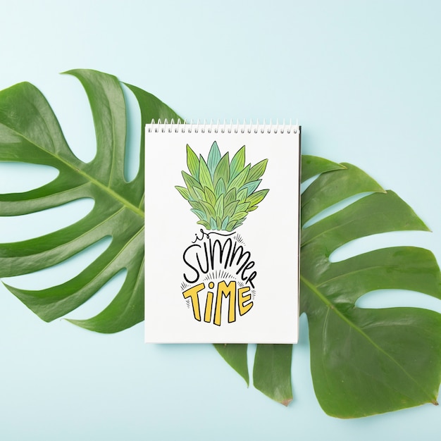 Spiral notepad mockup on palm leaf