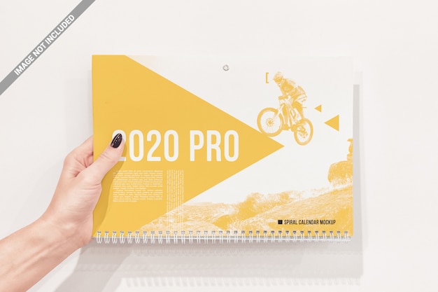 PSD spiral wall calendar in hand mockup