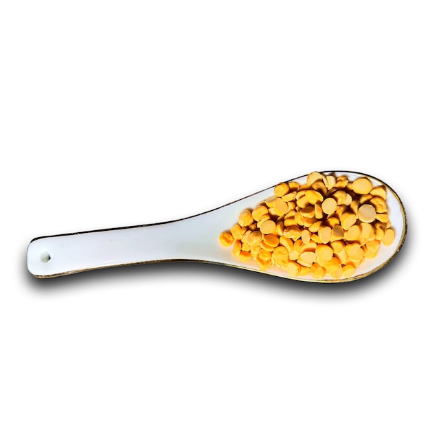 A spoon with a yellow dal in it