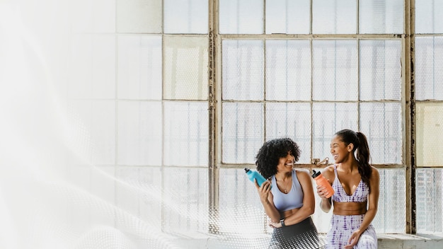 PSD sportive women talking in a gym while drinking water mockup