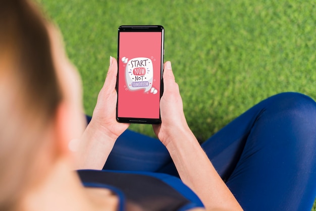 PSD sporty woman using smartphone mockup