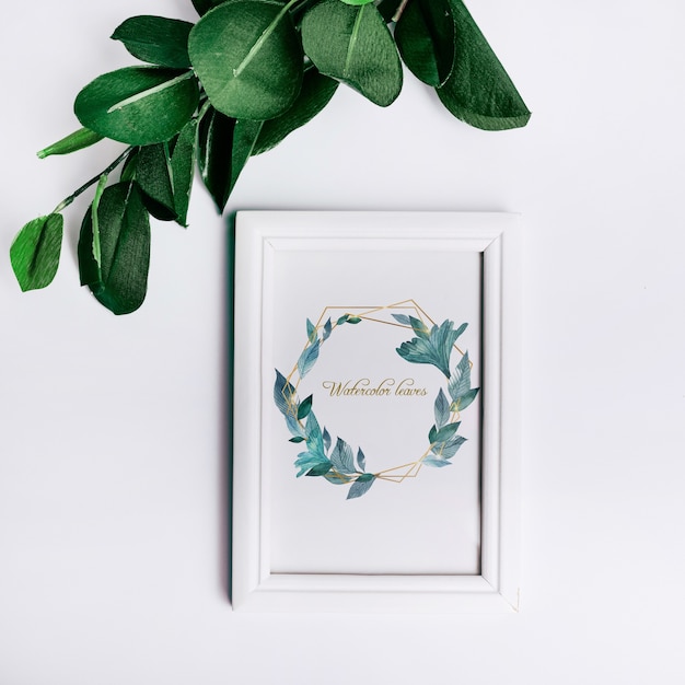 Spring frame mockup with decorative leaves in top view