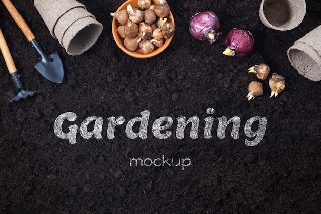 Spring gardening background. Gardening tools with hyacinth and crocus bulbs on fertile soil texture background. Top view, copy space.