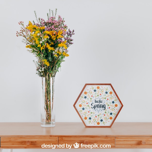 PSD spring mockup with hexagonal frame and vase of flowers over table