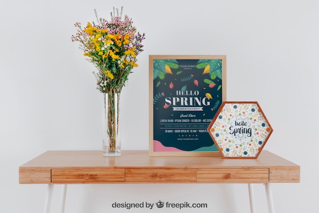 Spring mockup with two frames and vase of flowers over table