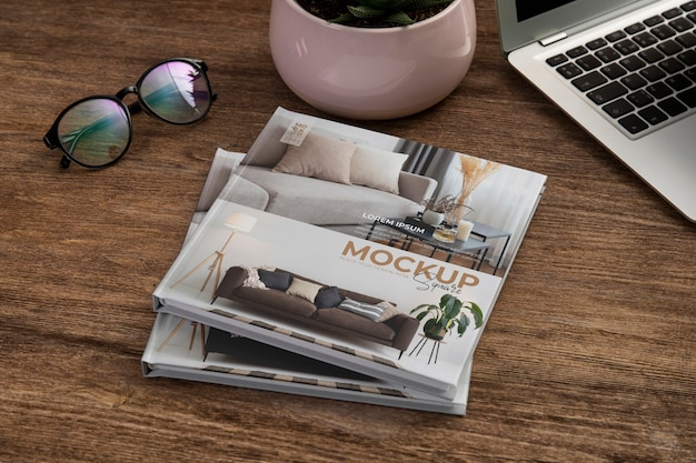 Square book mock-up on wooden office desk with laptop and eyeglasses