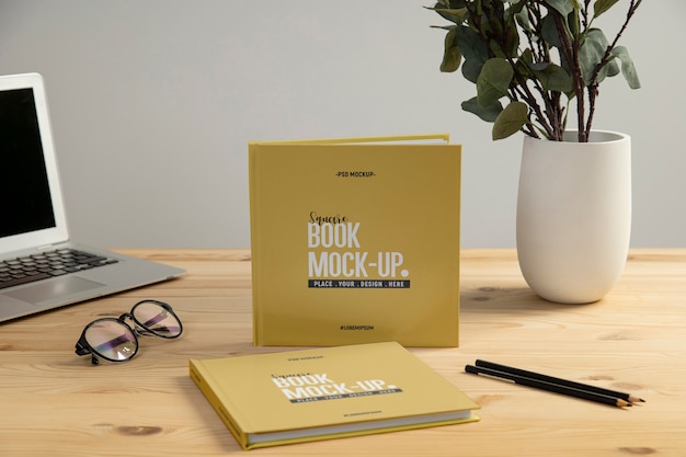 Square book mock-up on wooden office desk