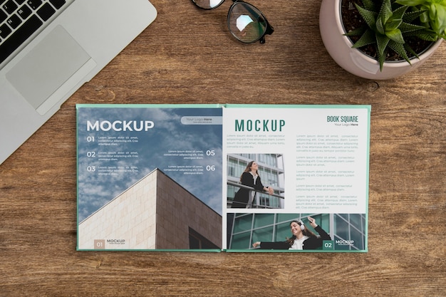 Square book mock-up on wooden office desk