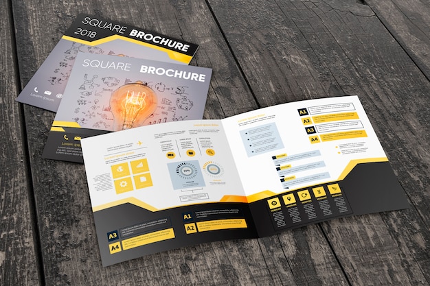 square brochure mockup on wooden surface