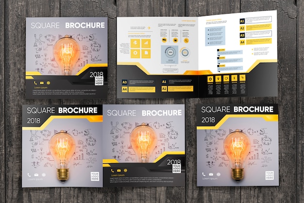 PSD square brochure mockup on wooden surface