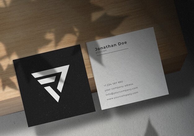 Square business card mockup design on wooden board