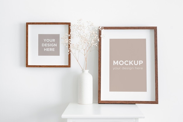 Square and portrait picture frame mockup on white wall with dry gypsophila plant decorations