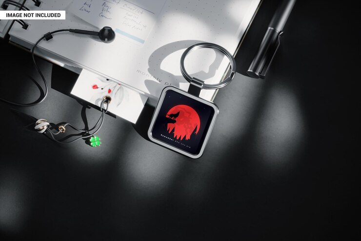 PSD square silver keychain on open notebook mockup