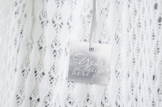 square tag on the on a knitted light background