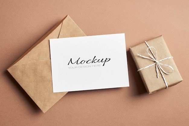 Stationary greeting card mockup with craft envelope and gift box