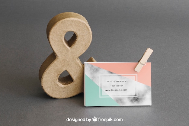 PSD stationery mockup with business card leaning against ampersand