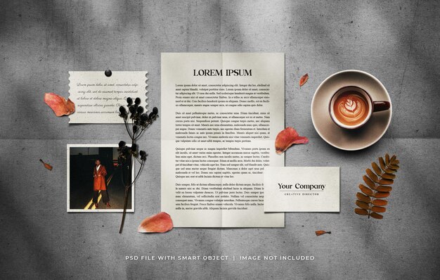 PSD stationery set mockup with a cup of coffee and dried plants