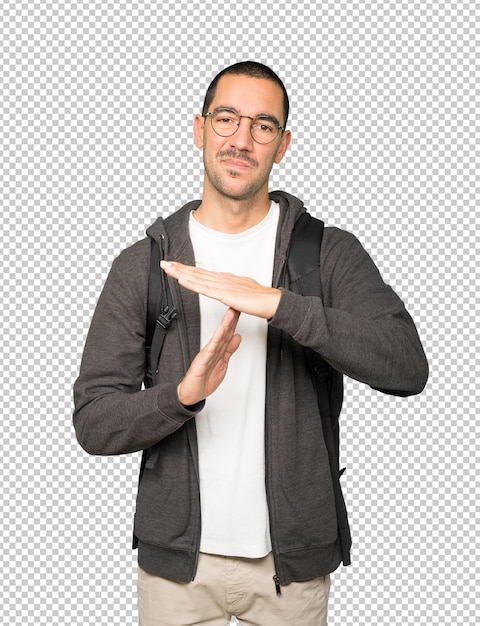 Stressed student making a time out gesture with his hands