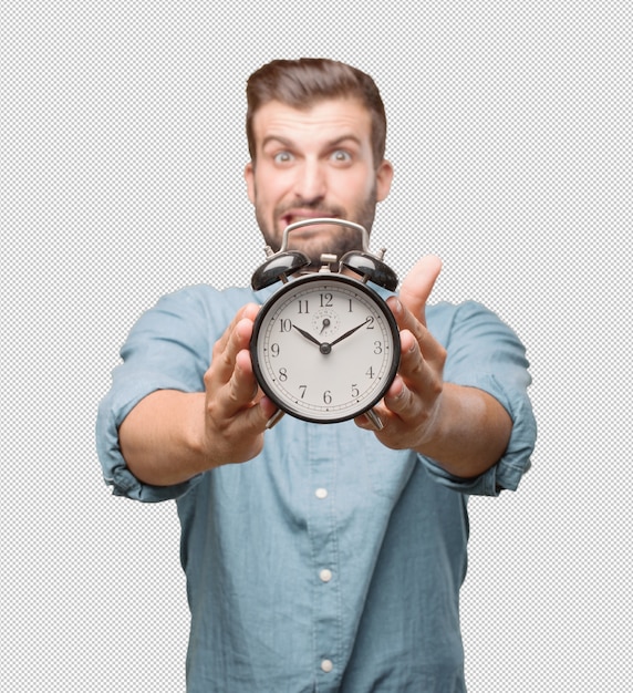 Stressed young man holding alarm clock