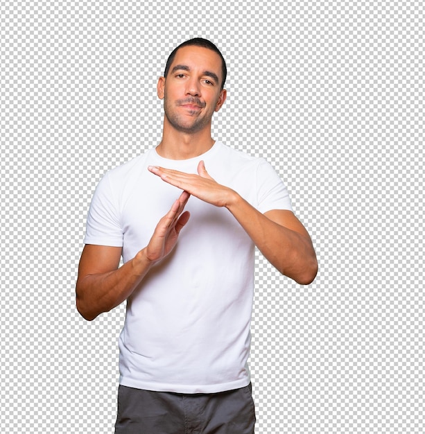 Stressed young man making a time out gesture with his hands