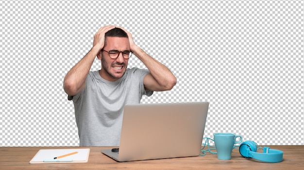 PSD stressed young man sitting at his desk