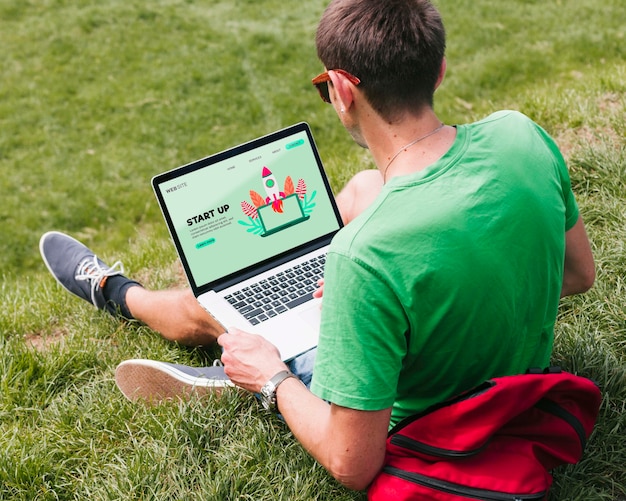 Student working on laptop outdoors