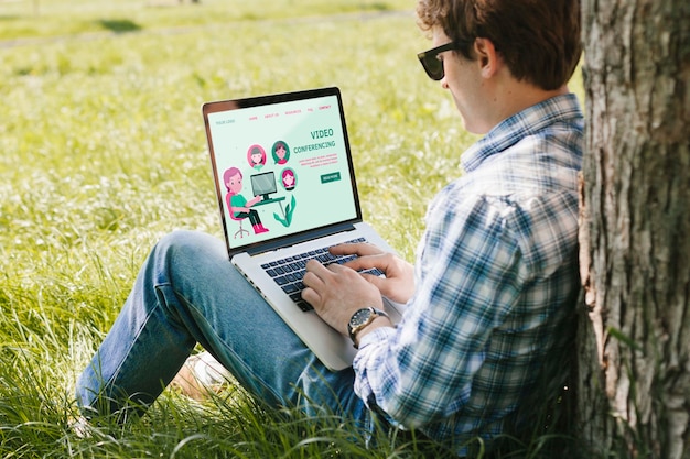 Student working on laptop outdoors