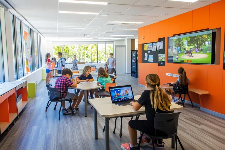 PSD students learning in modern brightly colored classroom engaging in various activities including using technology and collaborating
