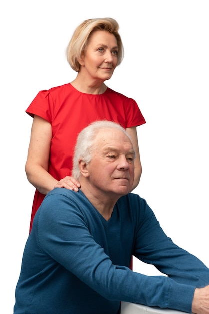 Studio portrait of loving elderly couple