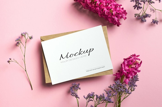 Stylish stationary card mockup on pink color paper with limonium and hyacinth flowers