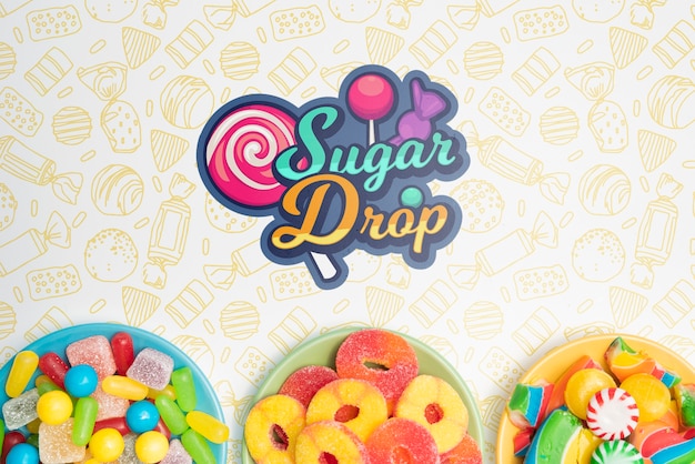 sugar drop and plates with delicious assortments of candies
