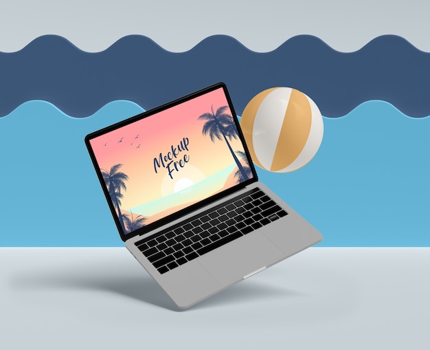 Summer concept with laptop and ball