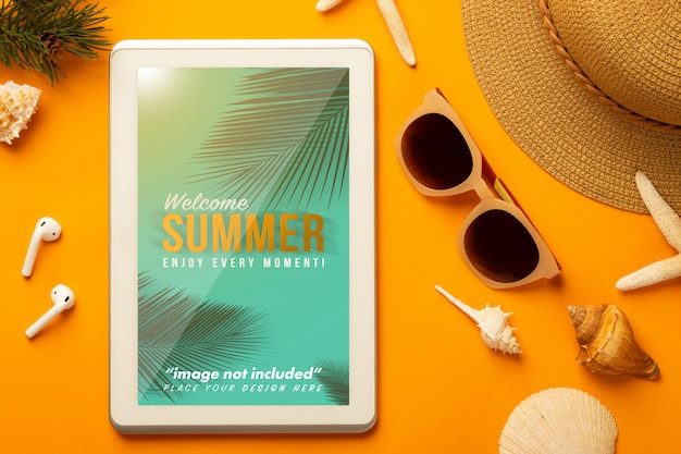 PSD summer scene with tablet mockup and beach accessories