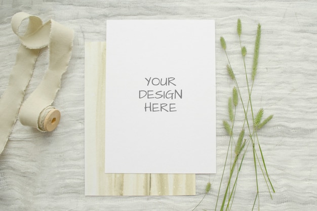 Summer stationery mockup ard for greeting card or wedding invitation with herbs, vintage spool of cotton braid on white