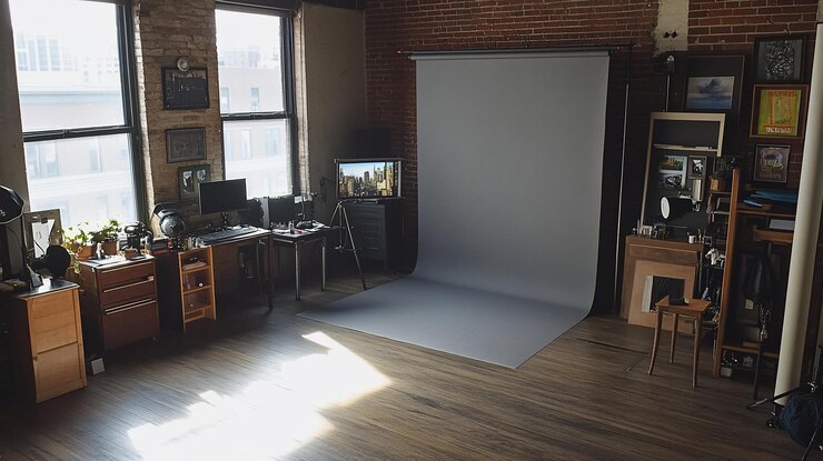 PSD sunlit loft studio with backdrop desk and equipment