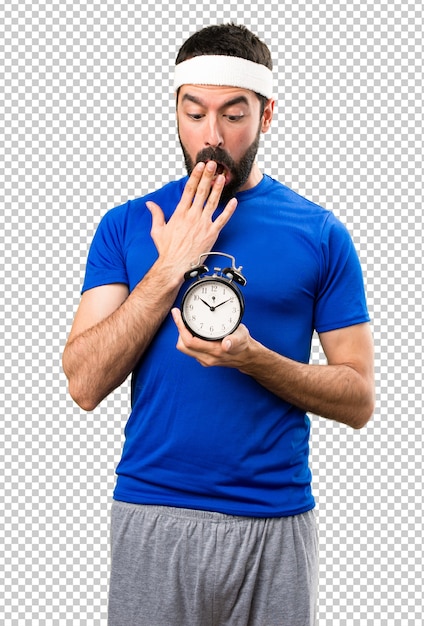 Surprised Funny sportsman holding vintage clock