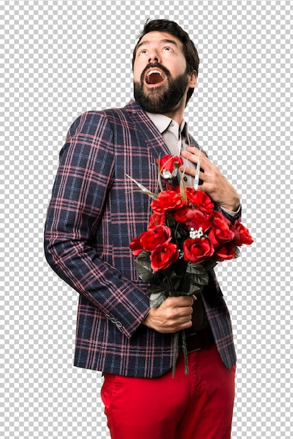 Surprised well dressed man holding flowers