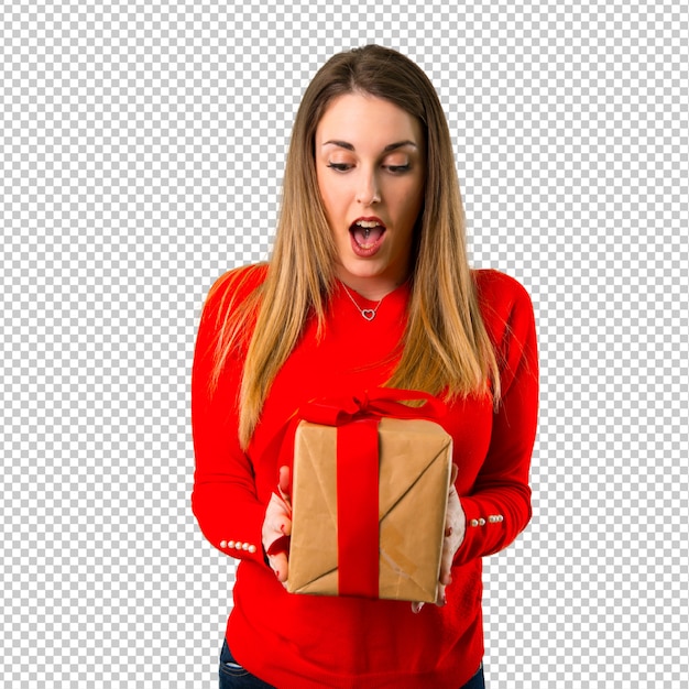 Surprised young blonde woman holding a gift